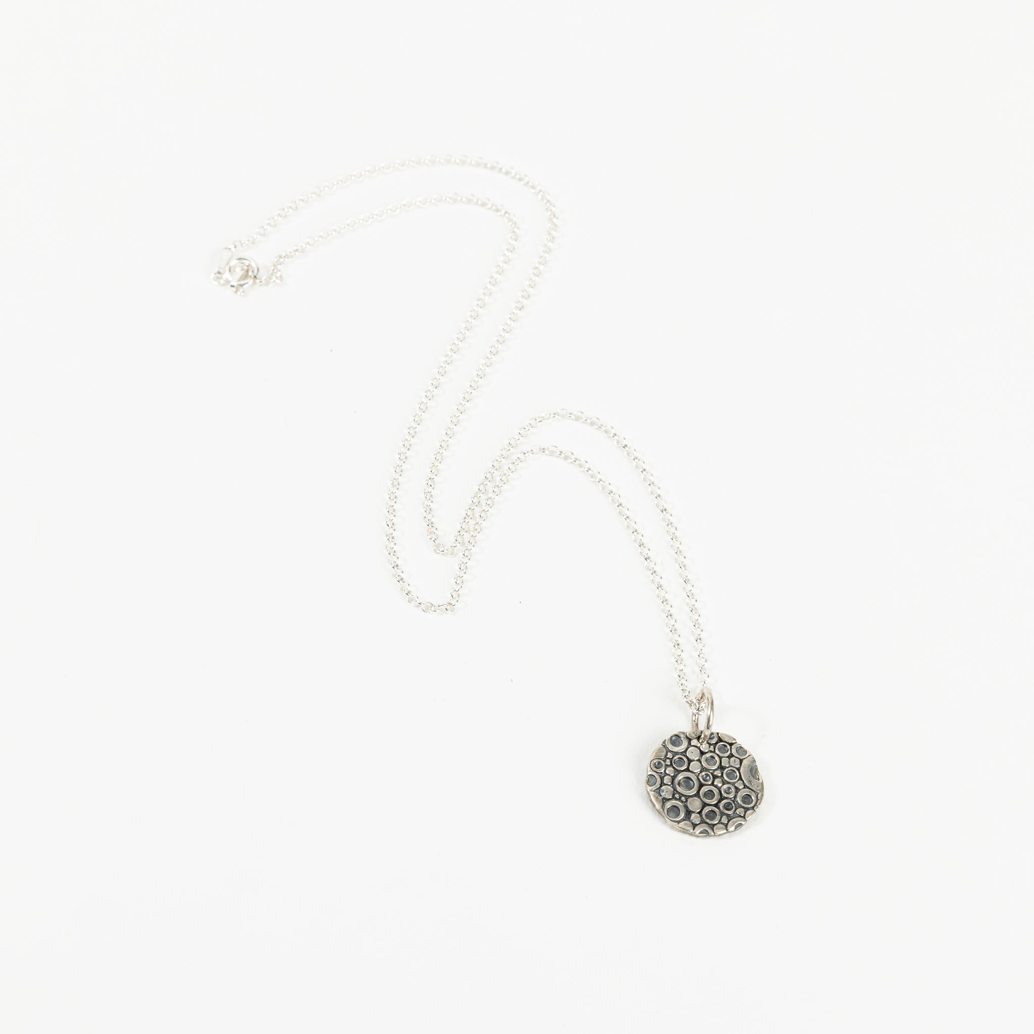 Small coin with jump ring and chain