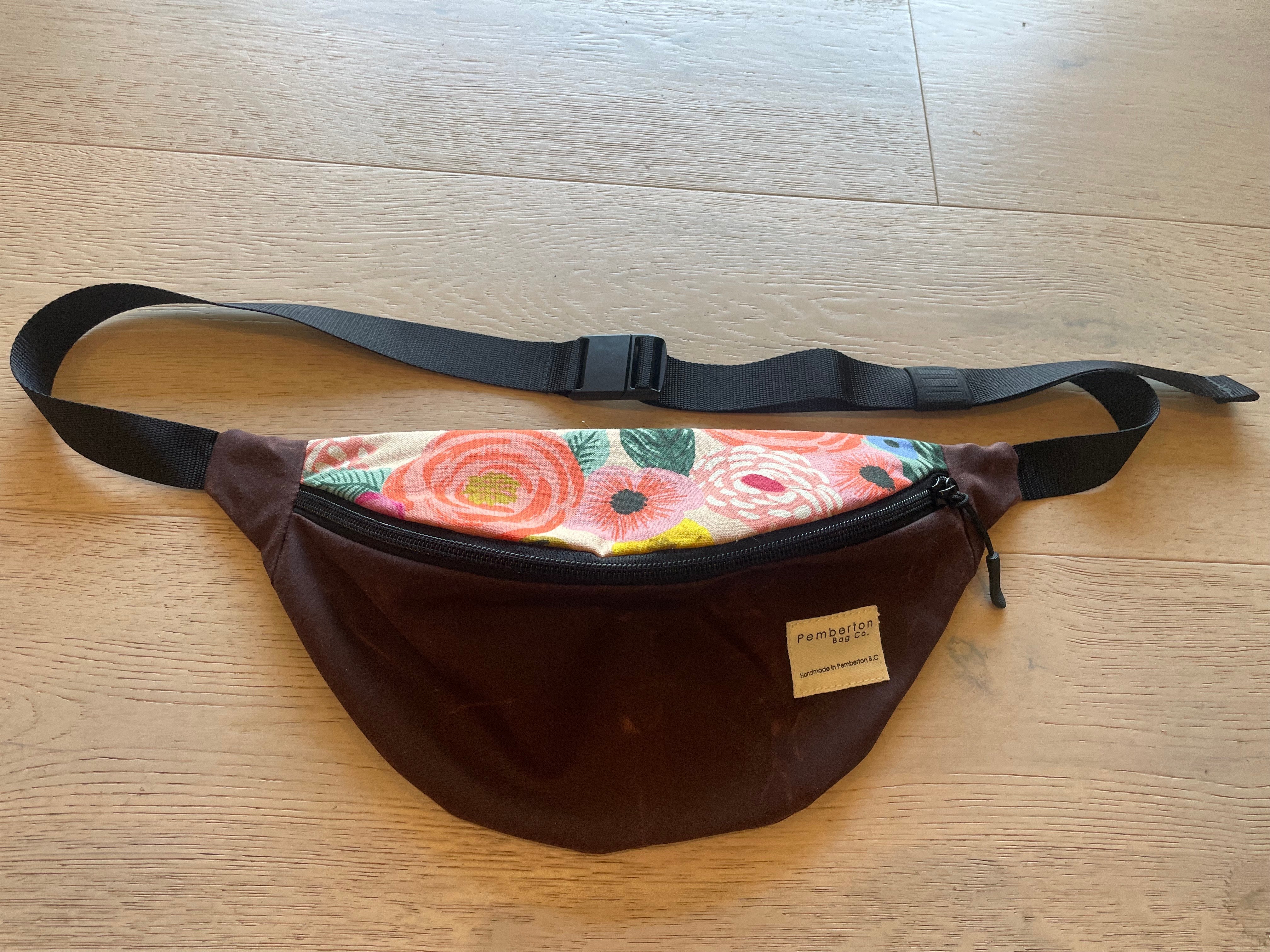 Burgundy oilskin fanny pack with floral top.