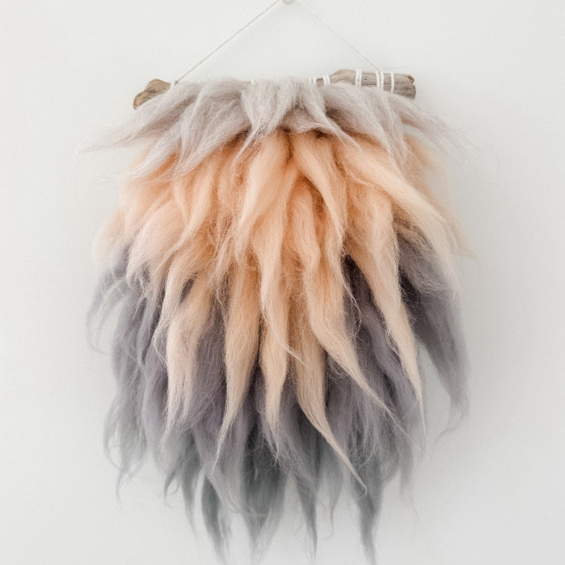 Fur wall hanging with gradient colors on a white background