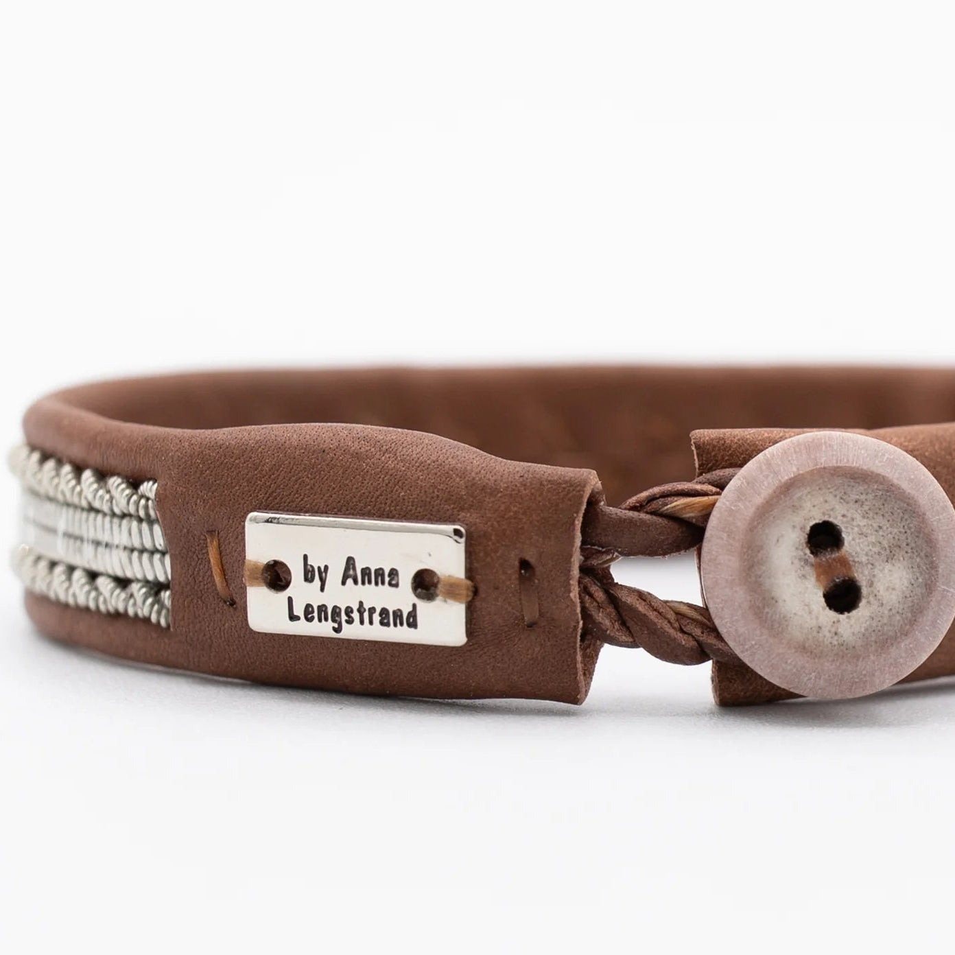Brown leather bracelet with silver thread and reindeer button