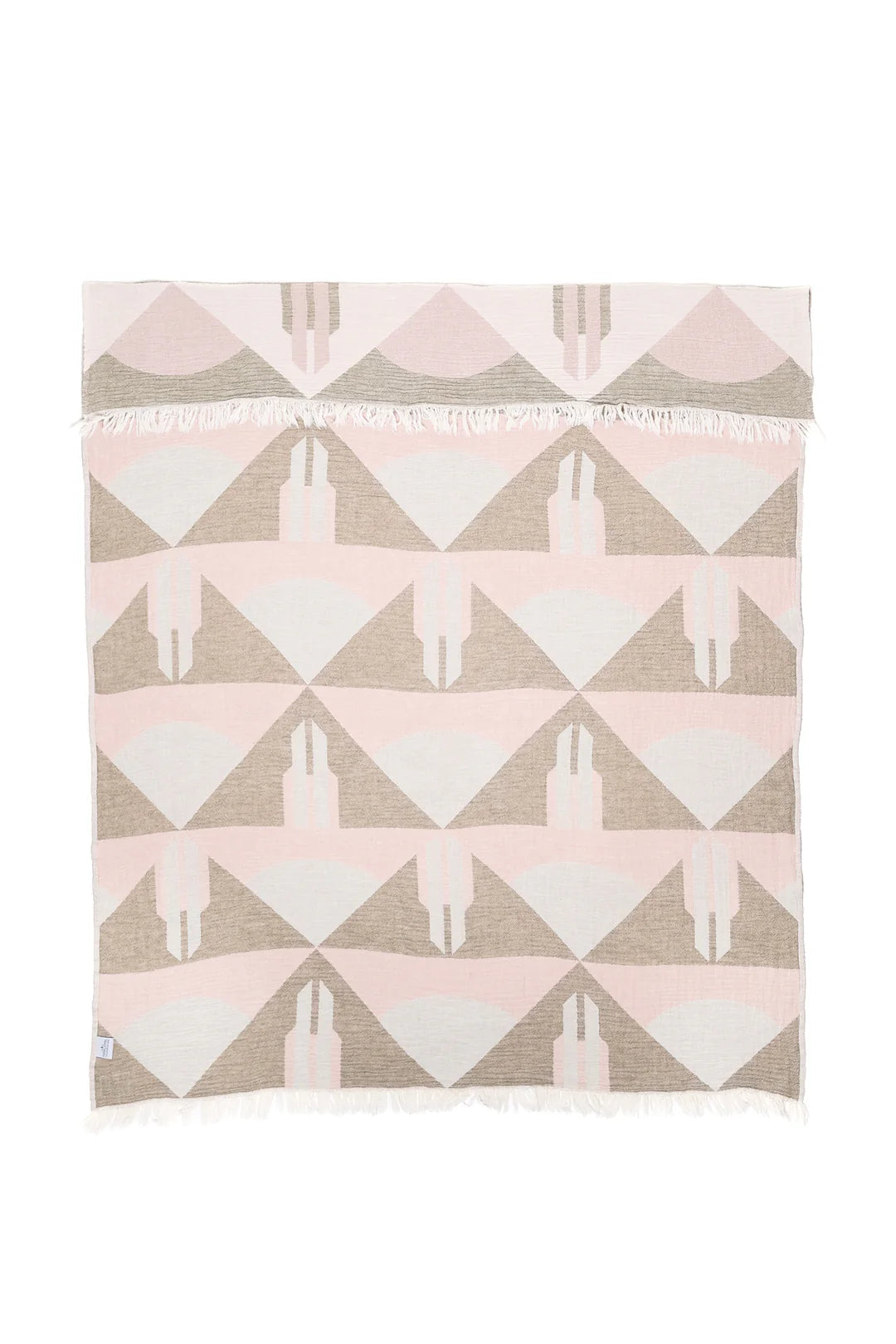 Blanket with geometric triangle pattern in pink, white, and beige on a white background